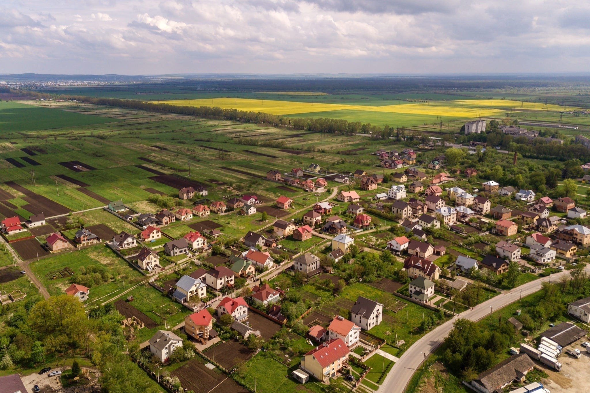 aerial landscape small town village with rows residential homes green trees copy - Aerial landscape of small town or village with rows of residential homes and green trees.